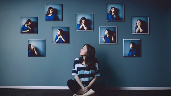 Woman looking at framed photos of herself