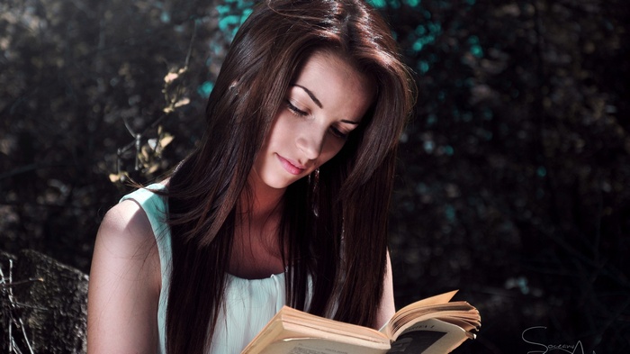 Woman reading a book outdoors