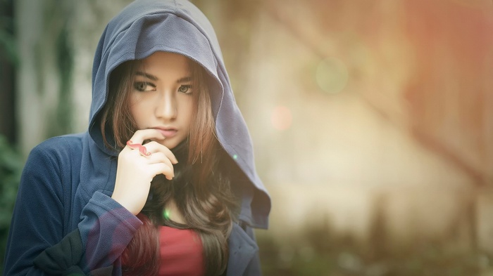 Woman wearing a blue hoodie with a red shirt