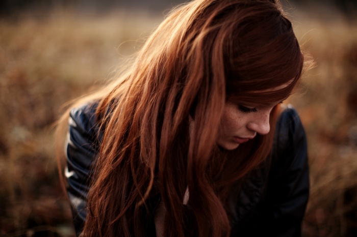 Woman with long red hair and freckles