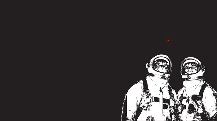 Two cats in astronaut suits looking at a red dot