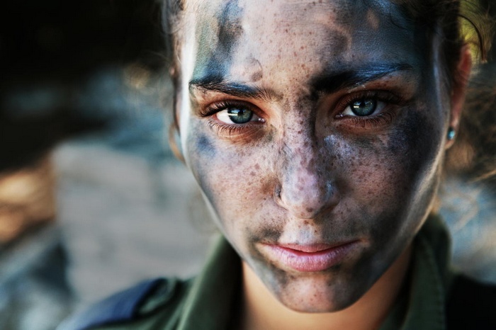 Woman with camouflage face paint