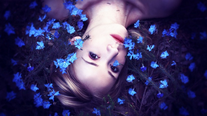 Woman lying down with blue flowers