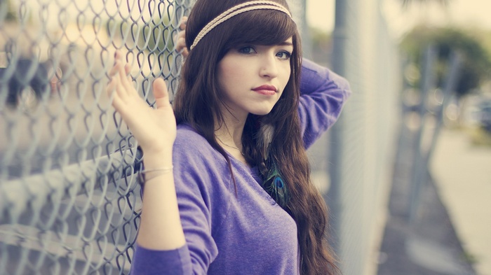 Woman with headband and purple sweater