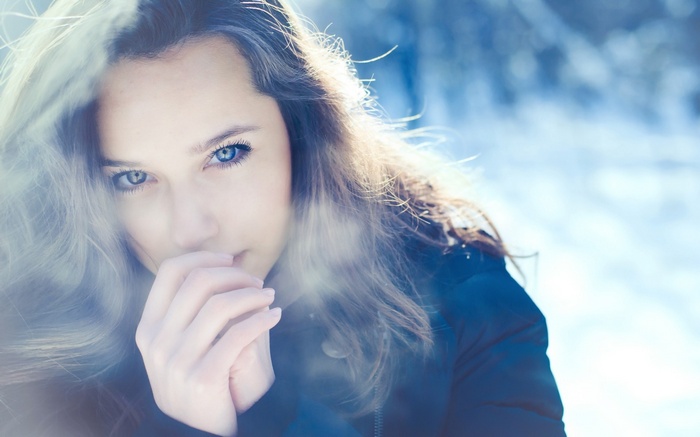 Woman with blue eyes in winter
