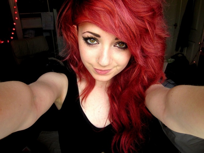 Young woman with bright red hair taking a selfie