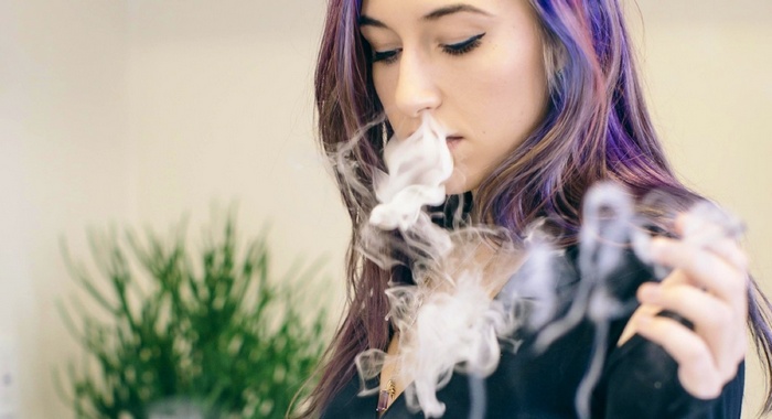 Woman with purple hair smoking