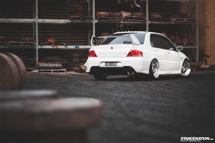 White Mitsubishi Lancer EVO with custom wheels