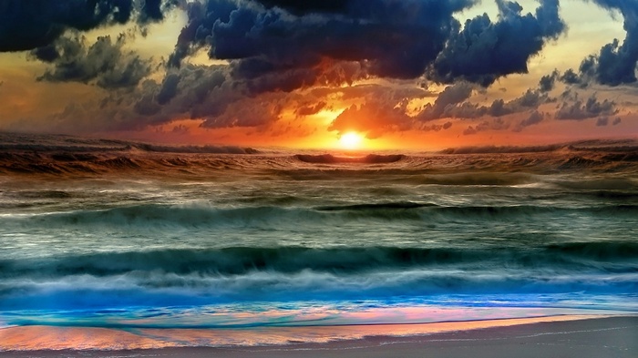 Sunset over the ocean with dramatic clouds