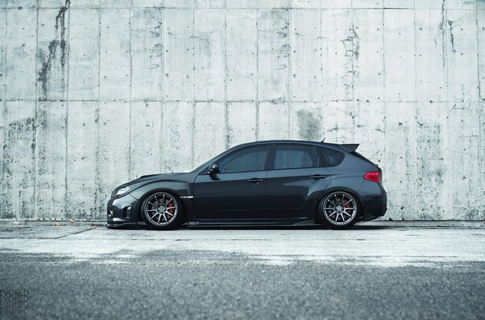 Subaru Impreza WRX STI hatchback parked against a concrete wall
