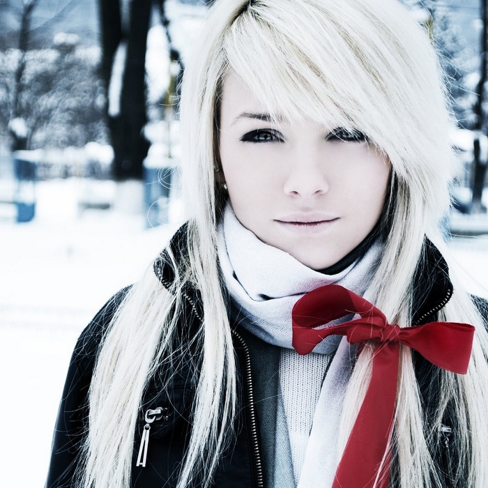 Laura Ivana with white hair and red ribbon in snow