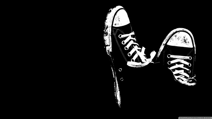 Converse All Stars shoes on black background