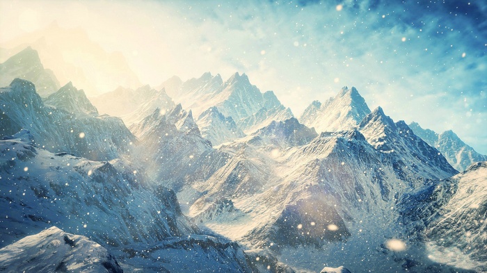 Snowy mountain range with falling snow