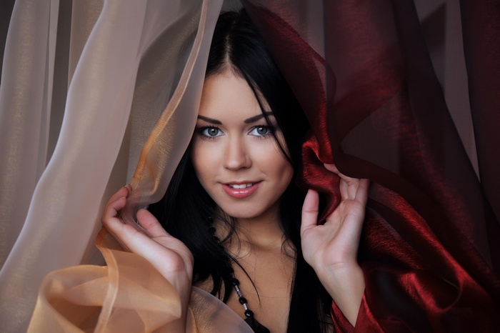 Macy B posing behind sheer curtains
