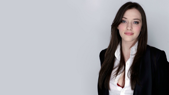 Kat Dennings wearing a white shirt and black jacket
