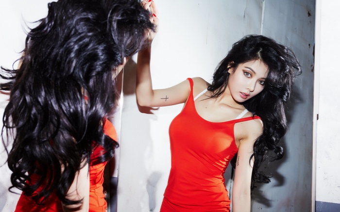 Hyuna with long black hair in a red dress