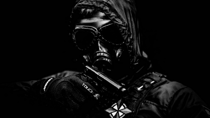 Person in gas mask holding a gun