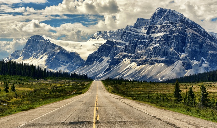 Road leading to snow-capped mountains
