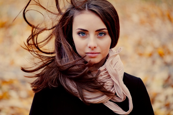 Ann Nevreva with blue eyes and scarf in the wind