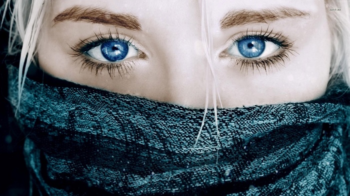 Close-up of a woman's blue eyes and scarf