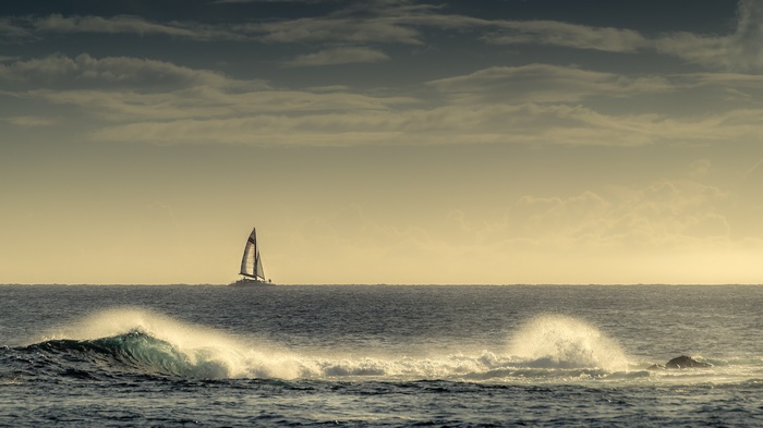 Sailboat on the ocean with waves