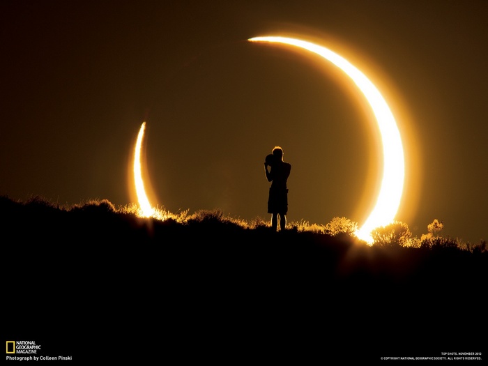 Solar eclipse with a photographer silhouetted against the sun