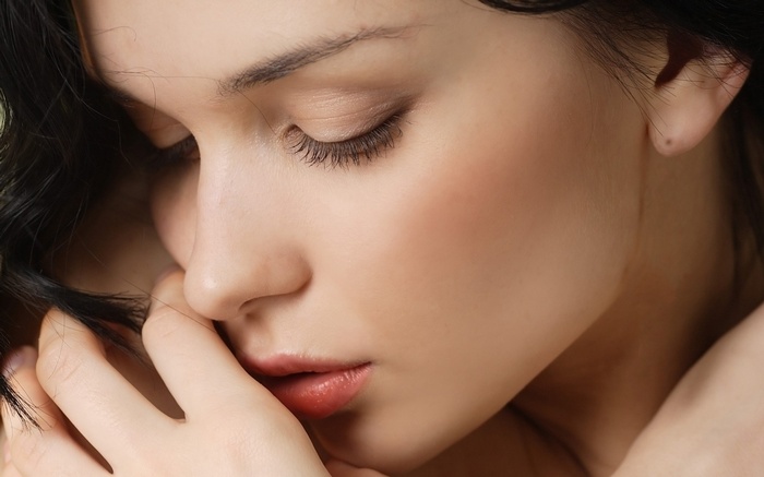 Katie Fey with black hair and closed eyes