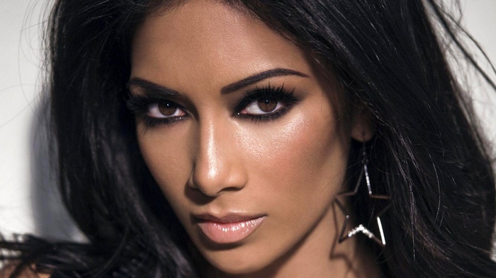 Nicole Scherzinger with dark hair and star earrings