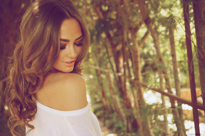 Woman with long brown hair and bare shoulders