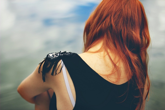 Woman with red hair looking away