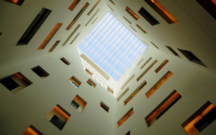 Worms eye view of modern architecture with skylight