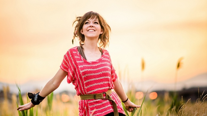 Lindsey Stirling in a field at sunset
