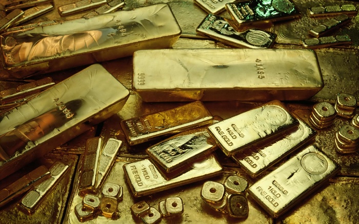 Gold bars and coins scattered on a golden surface