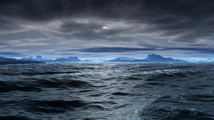 Dark sea with distant mountains under cloudy sky