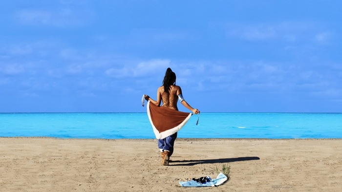 Korra cosplay on a beach with blue ocean