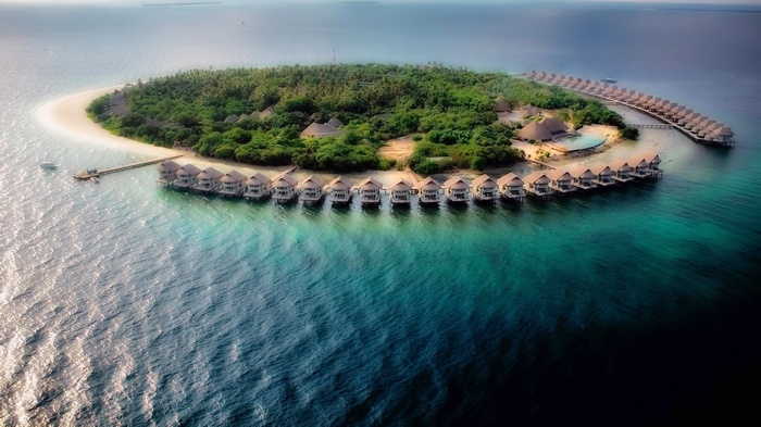 Island with overwater bungalows in the Maldives