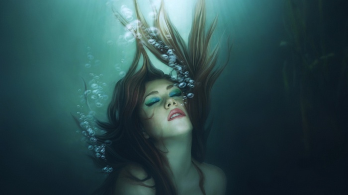 Woman underwater with bubbles
