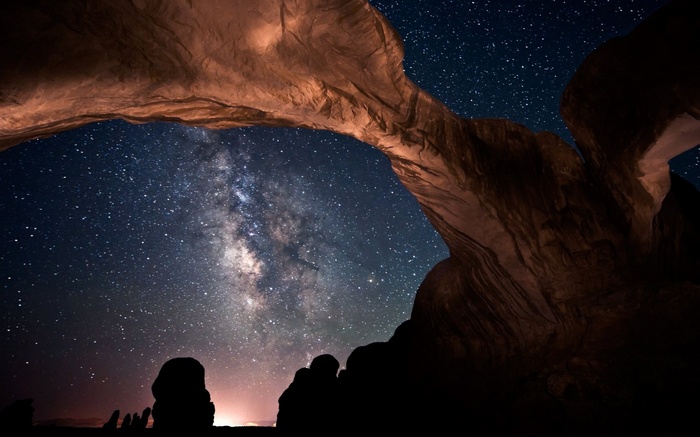 Milky Way seen through rock arch at Arches National Park