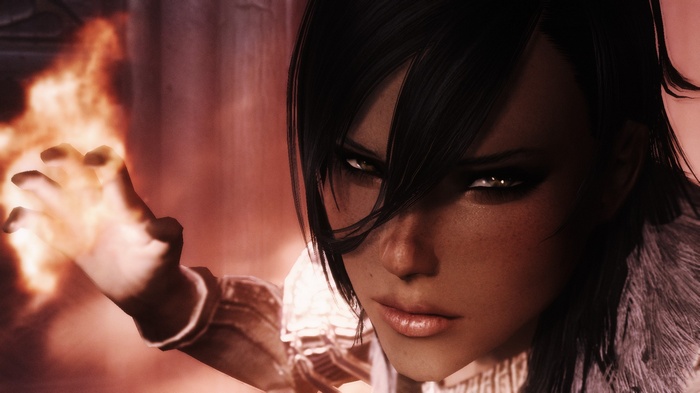 Woman casting fire magic in The Elder Scrolls V: Skyrim