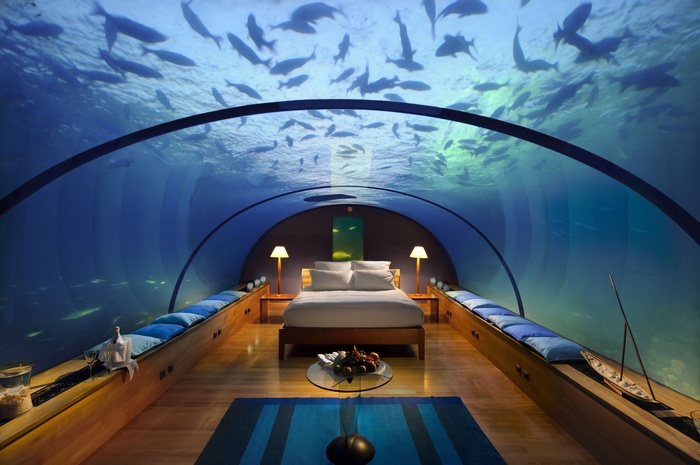 Underwater hotel bedroom with fish swimming above