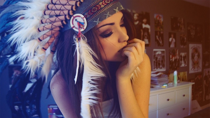 Melanie Iglesias wearing a Native American headdress