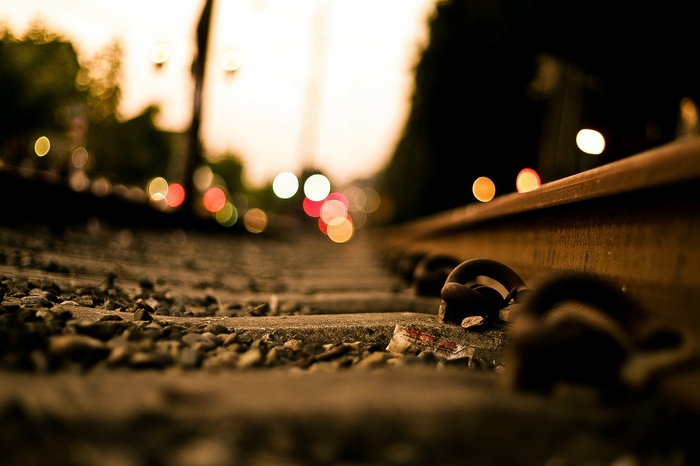 Train tracks with bokeh lights in the background