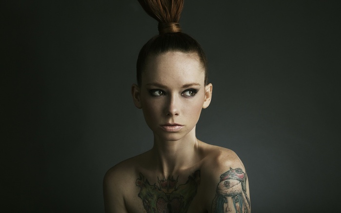 Hattie Watson with tattoos and bare shoulders