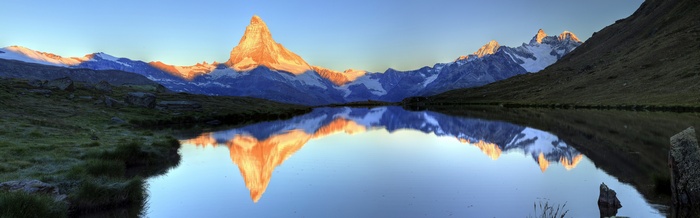 Matterhorn reflected in a calm lake at sunrise
