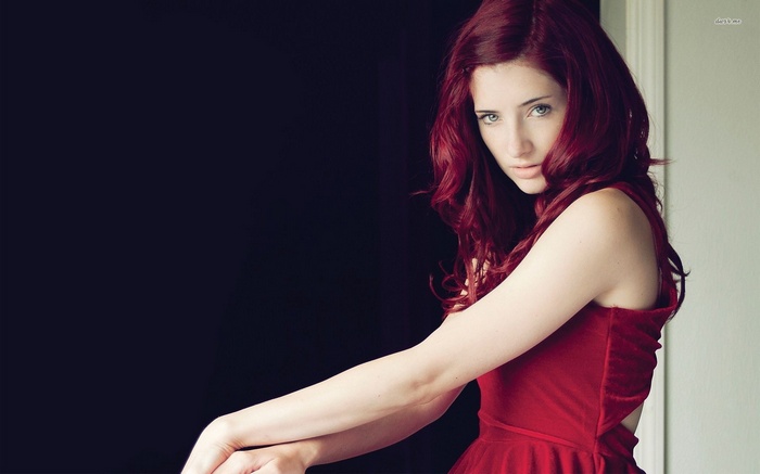 Susan Coffey with red hair in a red dress