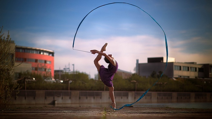 Woman performing gymnastics with a ribbon