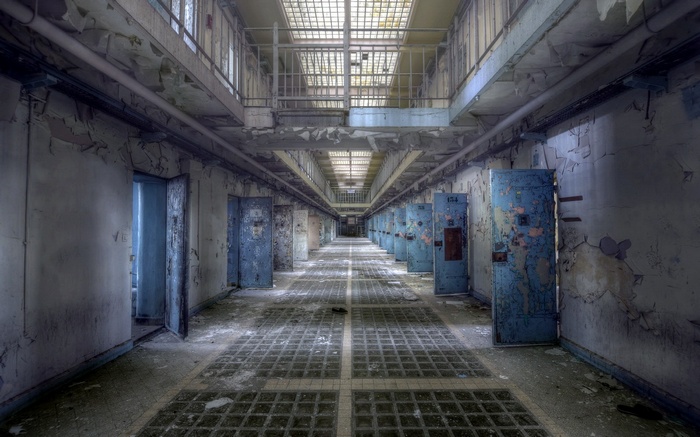 Abandoned prison hallway with cells