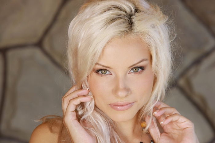 Adelia with blonde hair and green eyes