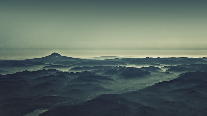 Misty mountain range with a prominent peak