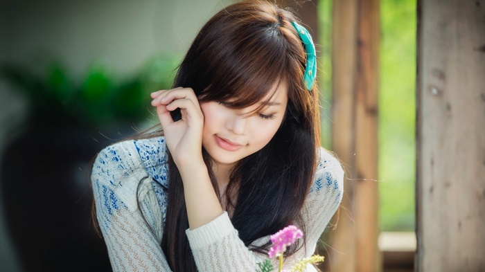 Asian woman with brown hair and a blue hair clip